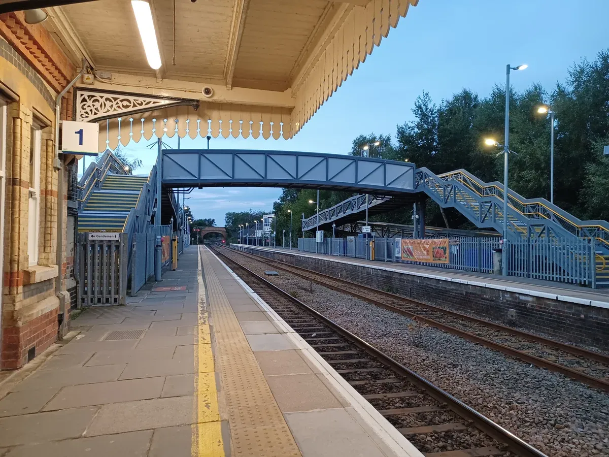 Platform and footbridge at Moreton-in-Marsh station on a train day trip from London to the Cotswolds
