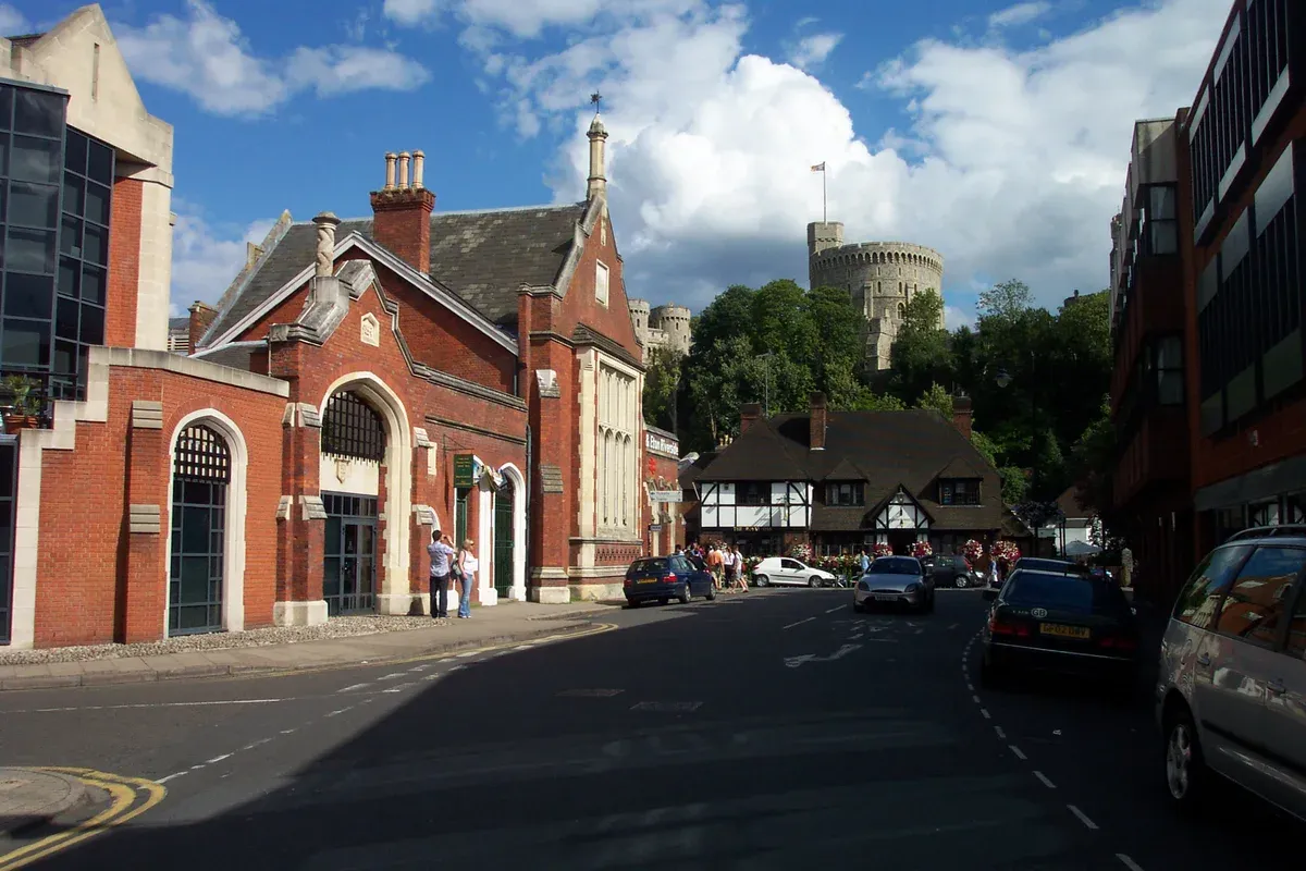 Brick frontage of Windsor and Eton Riverside station with the castle behind on a day trip from London to Windsor Castle